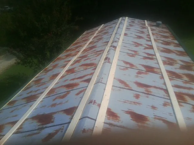 Rusted metal roof panels with new wood purlins before replacement — Storm Damage Roof Repair in Trout Run by Roofing Brothers