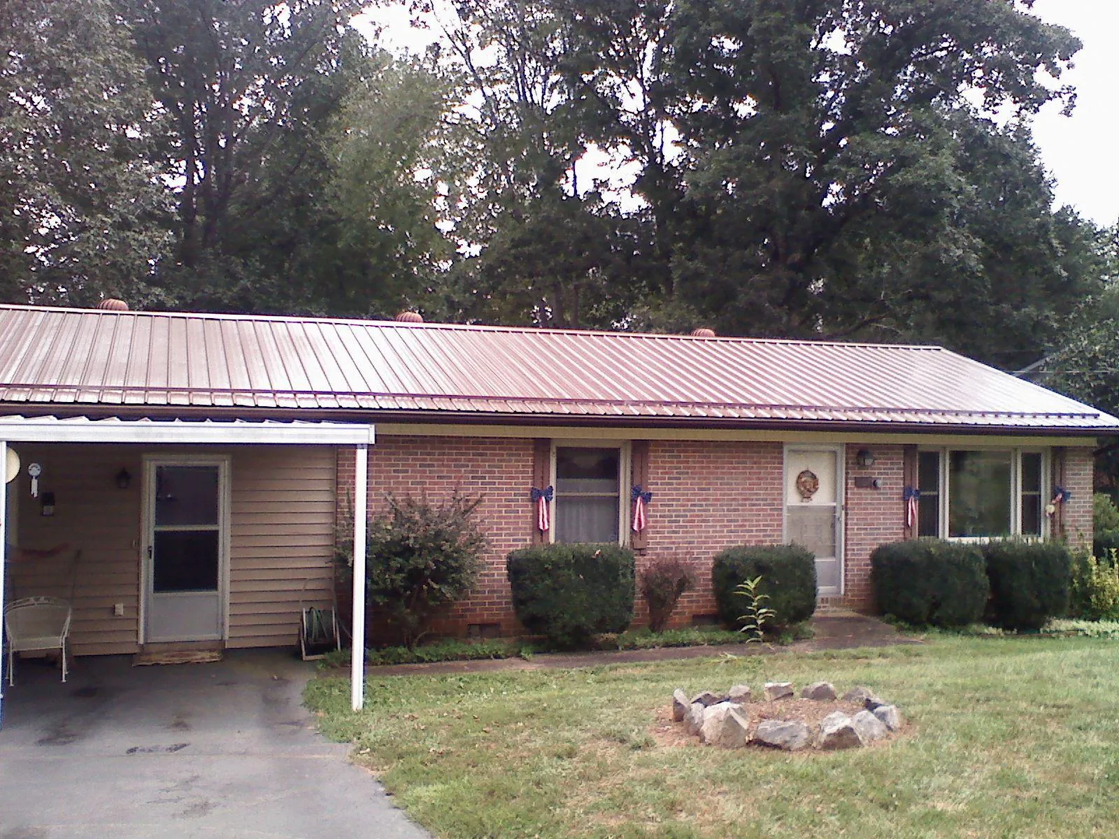 Bronze metal roof and carport on a brick ranch home — Roof Repair work by our crew in Trout Run