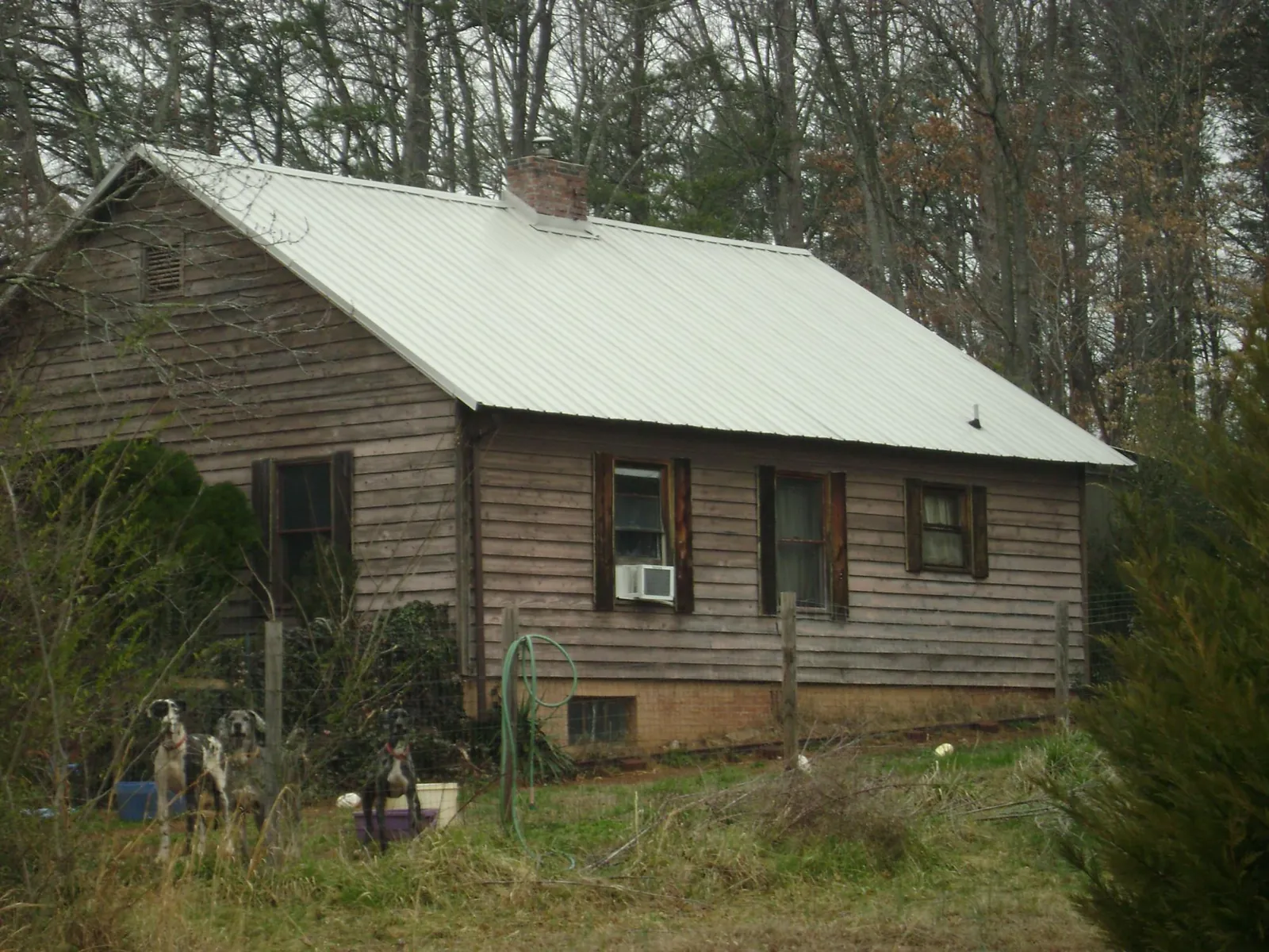 White metal roof on an old wood sided farmhouse, from a Metal Roof Installation job in Trout Run